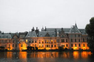 The Binnenhof, seat of the Dutch government and parliament in The Hague, reflected in the water at dusk